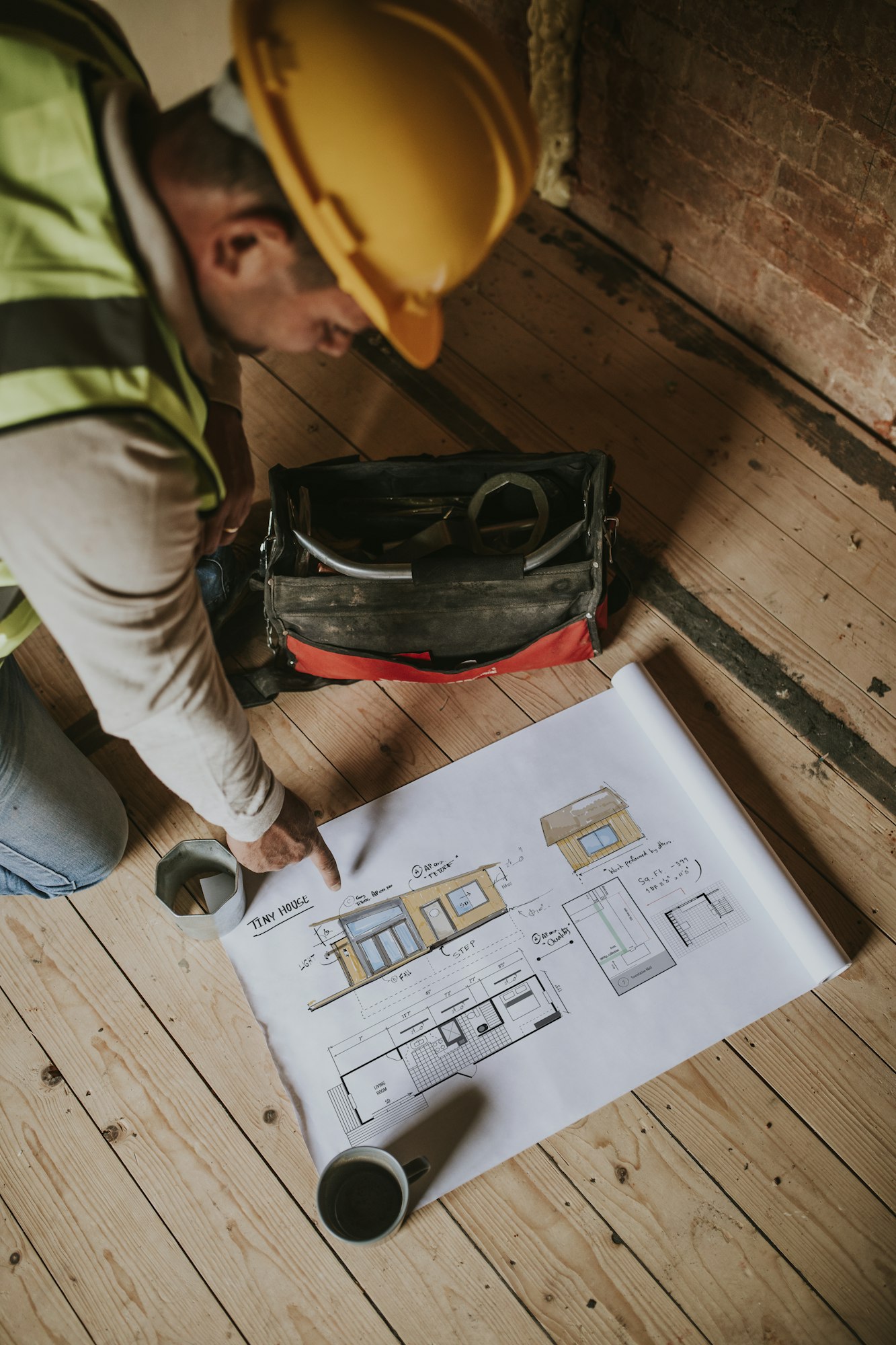 Contractors reading floor plan at a construction site